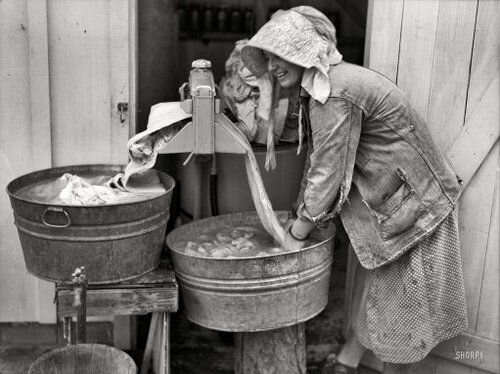 a woman washing clothes in pre-historic times